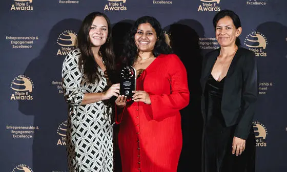 The LSE Generate team smile are the camera at Triple E awards